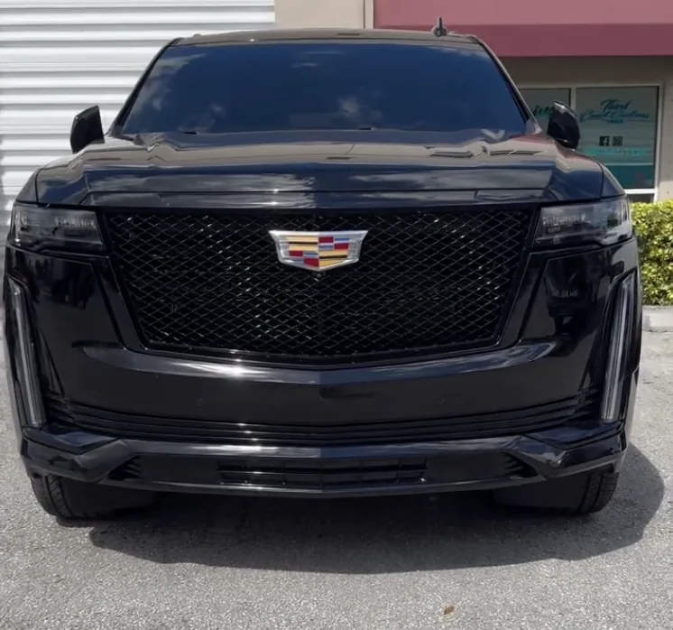 Black Cadillac Escalade with blacked-out trim and dark tint