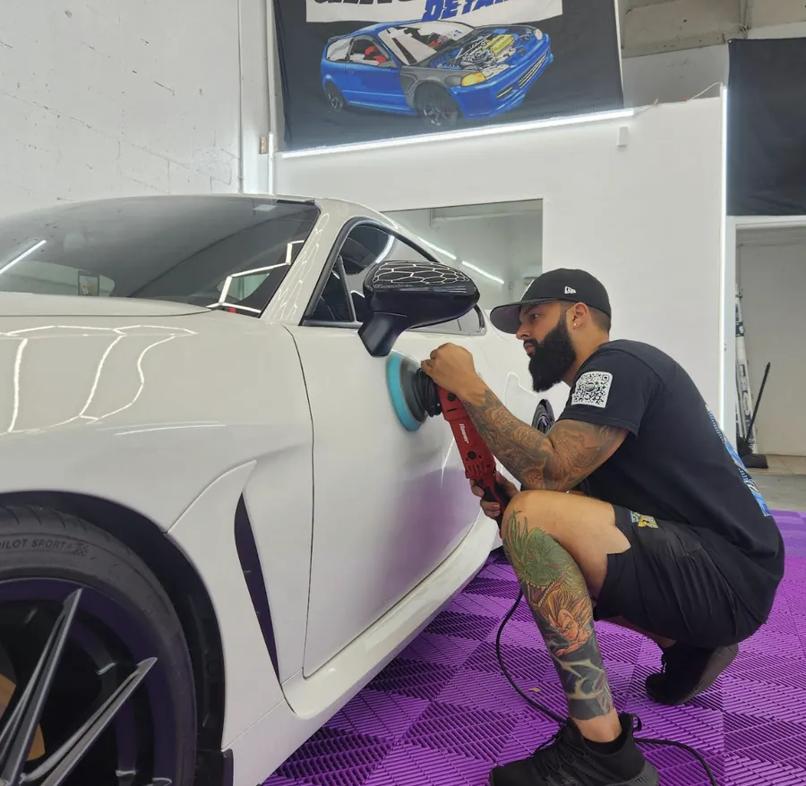 Gino polishing the paint on a white car
