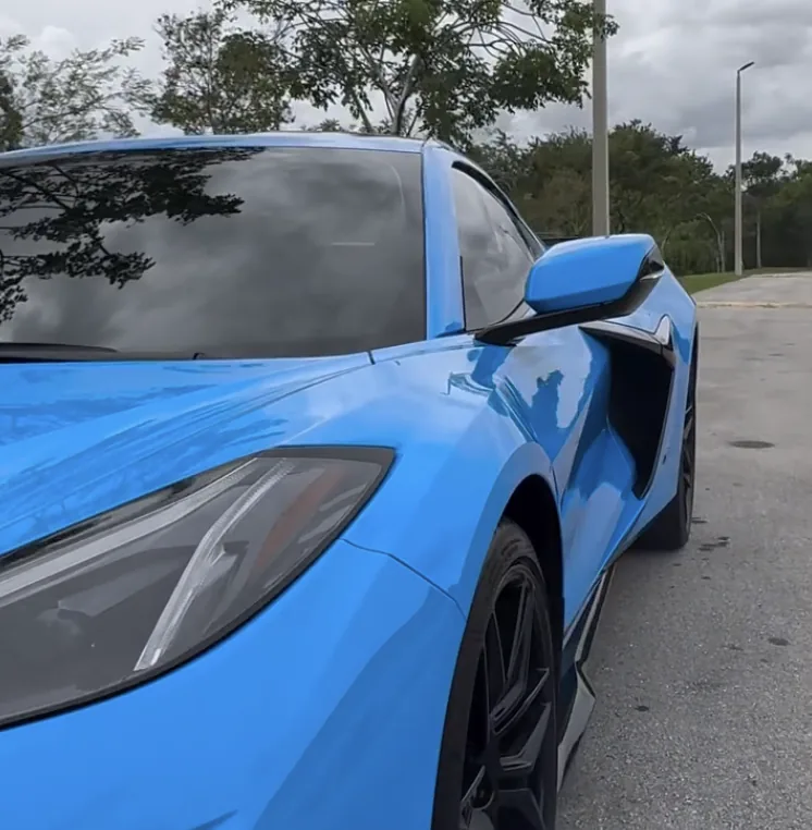 Blue McLaren with tinted side glass, close up